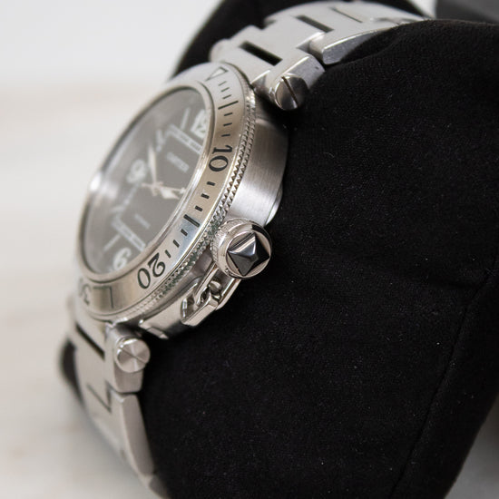 Silver watch on a black cloth with a white background
