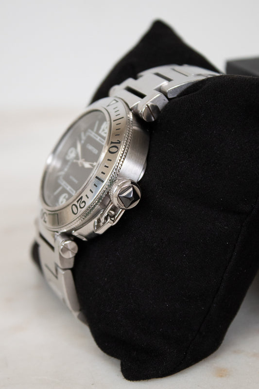 Silver watch on a black cloth with a white background