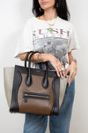Person holding a Celine handbag with a white background