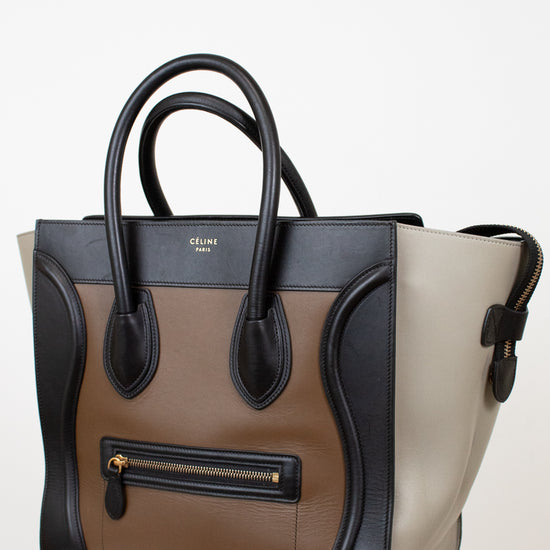 Multi-toned handbag with black and beige sections on a white background