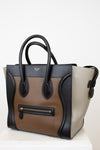 Multi-toned handbag with black and beige sections on a white background