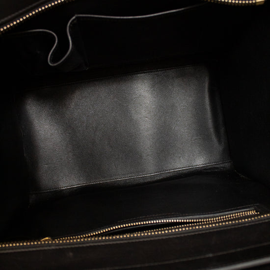 Black leather inside of handbag with gold zipper.