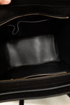 Black leather inside of handbag with gold zipper.