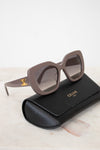Celine sunglasses on a marble surface with a black case