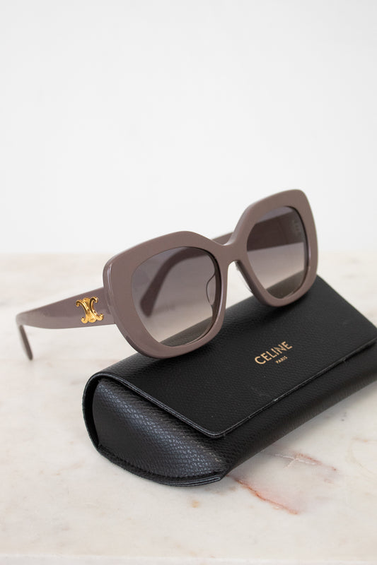 Celine sunglasses on a marble surface with a black case