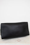 Black leather base of bag on a light marble surface