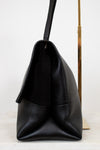 Black leather handbag on a white background