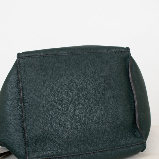 Green leather handbag on a light gray background