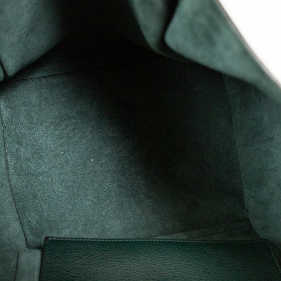 Close-up of a green leather bags interior with visible stitching