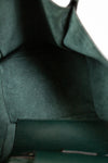 Close-up of a green leather bags interior with visible stitching