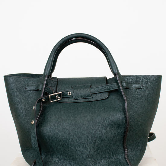 Green handbag with a strap on a white background