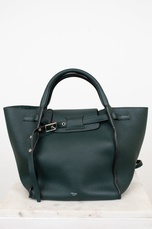 Green handbag with a strap on a white background