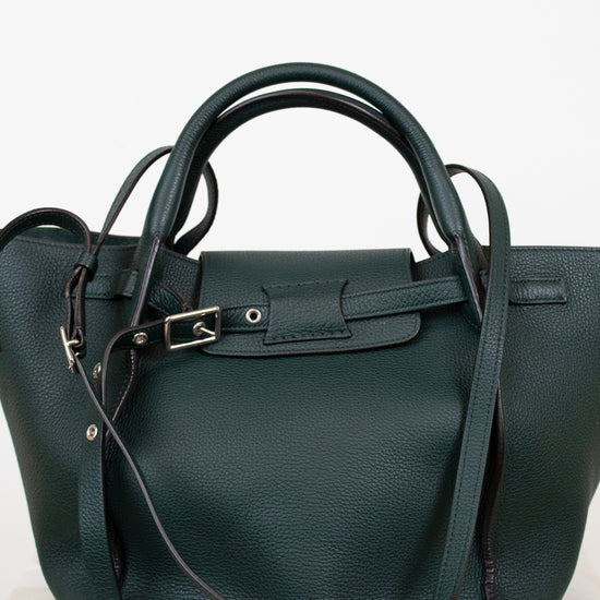 Green handbag with a strap on a white background