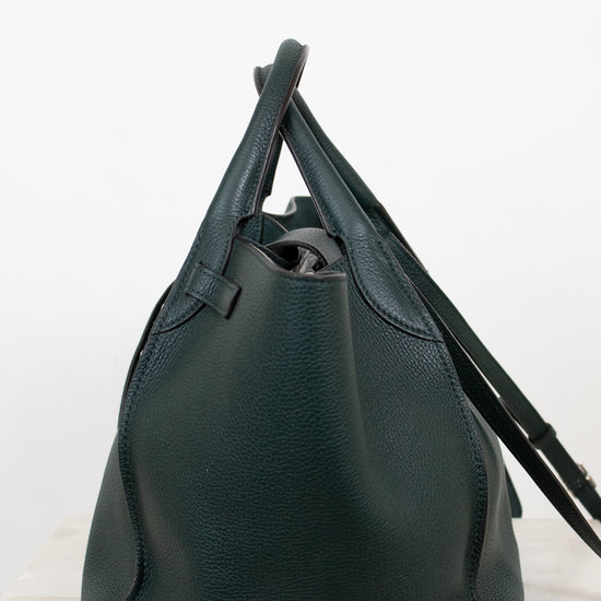 Green leather handbag on a white background
