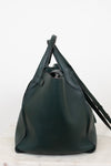 Green leather handbag on a white background