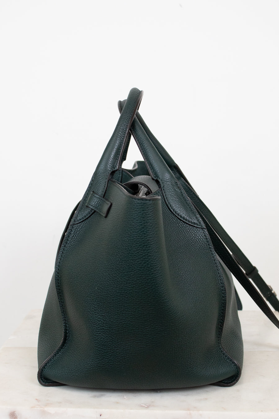 Green leather handbag on a white background