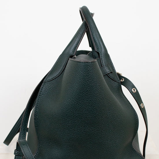 Green leather handbag on a white background