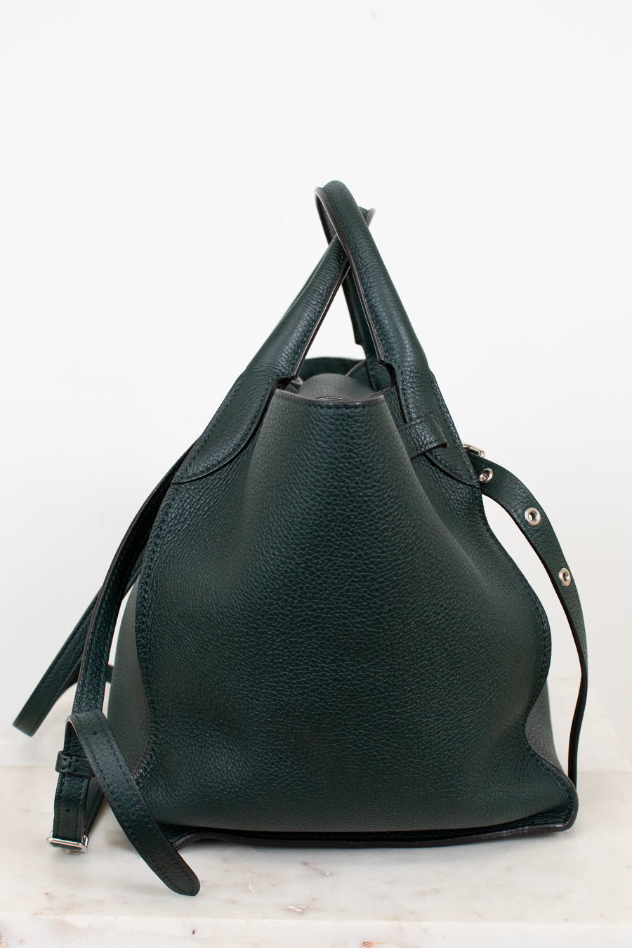 Green leather handbag on a white background