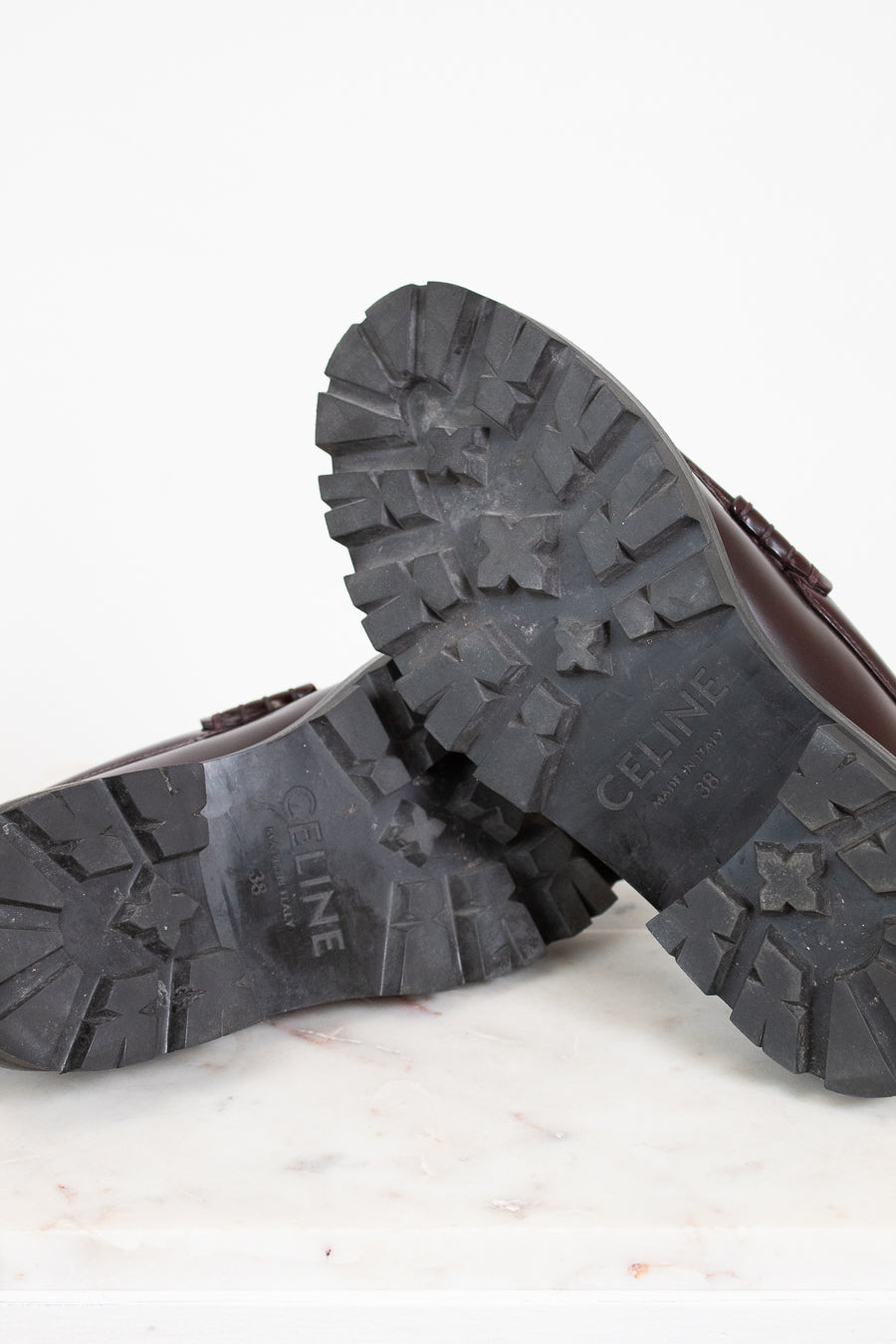 Close-up of loafers with 'CELINE' branding on a light background