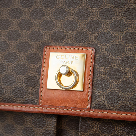 Close-up of a Celine bag with logo plaque on brown patterned fabric