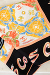 Chanel scarves with colorful designs and branding.