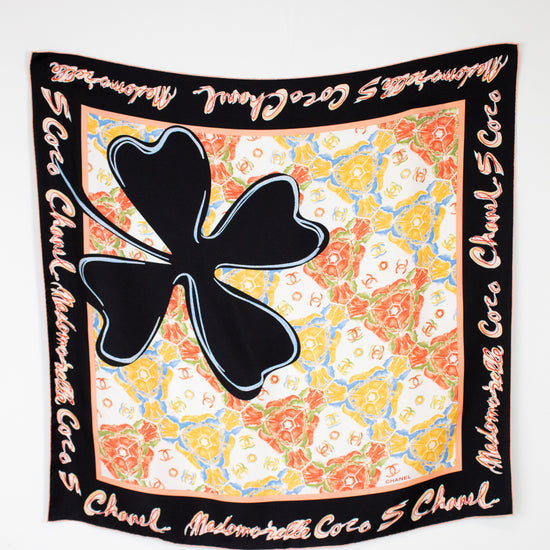 Chanel scarf with large black clover and colorful pattern on white background