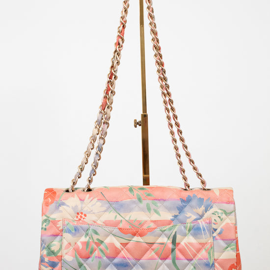 Floral quilted handbag back exterior with chain strap on a white background