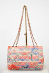 Floral quilted handbag back exterior with chain strap on a white background
