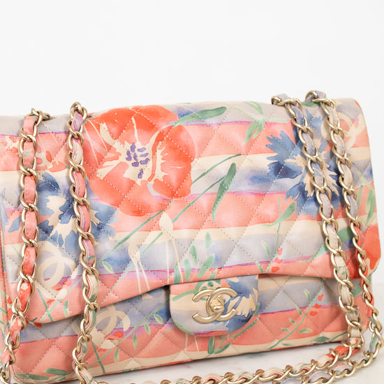 Floral patterned handbag with gold chain on a white background