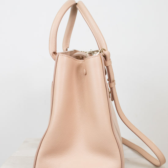 Beige handbag with a strap on a white background