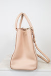 Beige handbag with a strap on a white background
