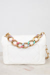 White quilted handbag with a gold chain strap featuring colorful links on a white background