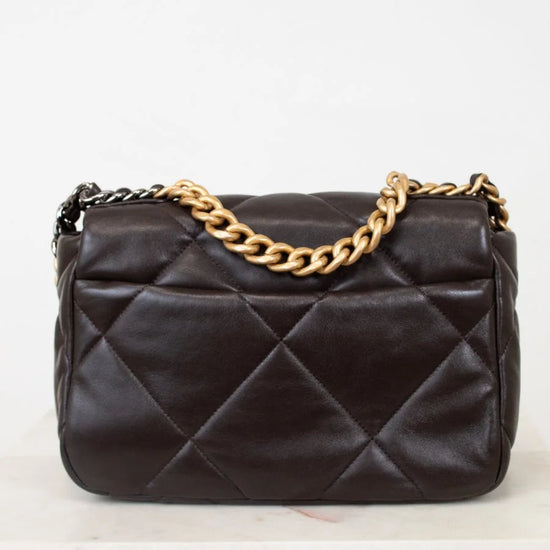 Dark Brown quilted handbag with a gold chain strap on a white background