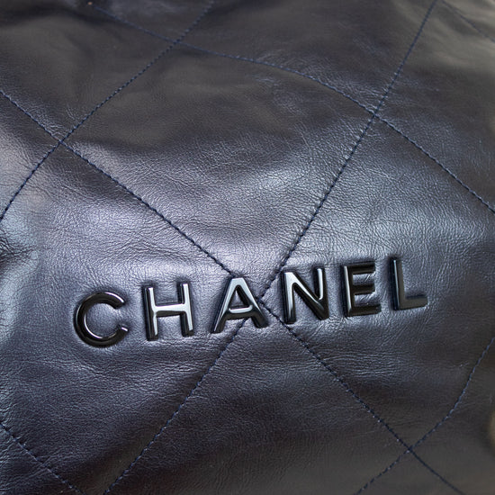 Close-up of a quilted navy leather Chanel handbag.