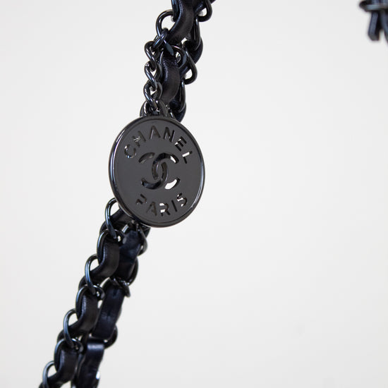 Navy chain with a Chanel logo tag on a white background