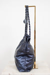 Navy leather handbag with chain handle on a white background