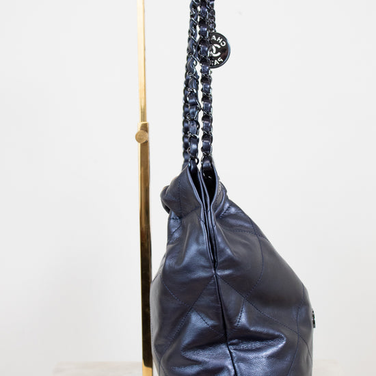 Navy leather handbag with a chain strap on a white background