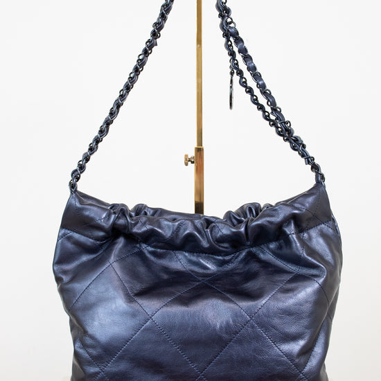 Blue metallic  leather handbag with chain strap on a white background
