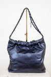 Blue metallic  leather handbag with chain strap on a white background