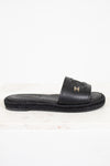 Black sandal with a brand logo on a white background