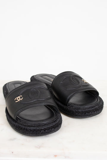 Black slides with Chanel logo on a white background