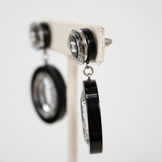 Pair of earrings with black and silver design on a white background