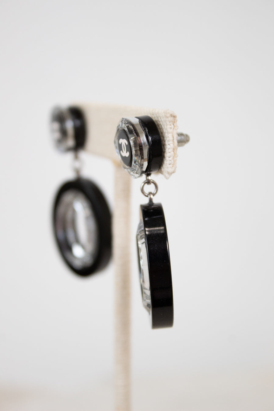 Pair of earrings with black and silver design on a white background