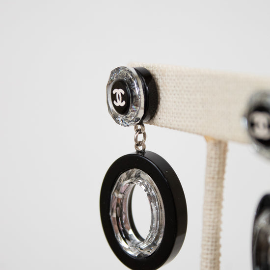 Black and clear earrings on a white background