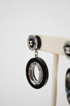 Black and clear earrings on a white background