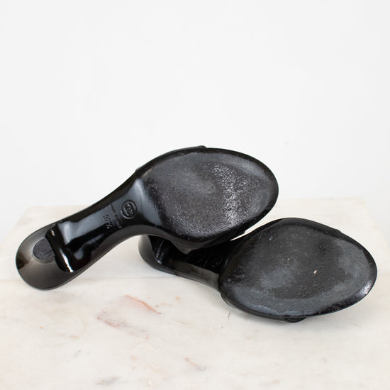 Black sole of Chanel kitten heels on a white marble surface