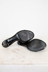 Black sole of Chanel kitten heels on a white marble surface