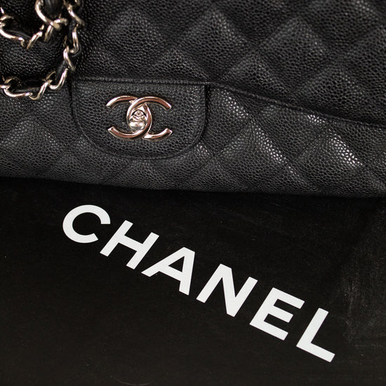 Close-up of a black quilted Chanel handbag with the brand logo.