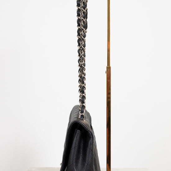 Black handbag with a chain strap on a white background