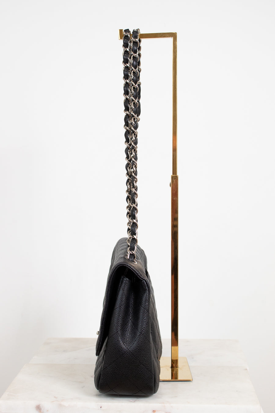 Black handbag with a chain strap on a white background